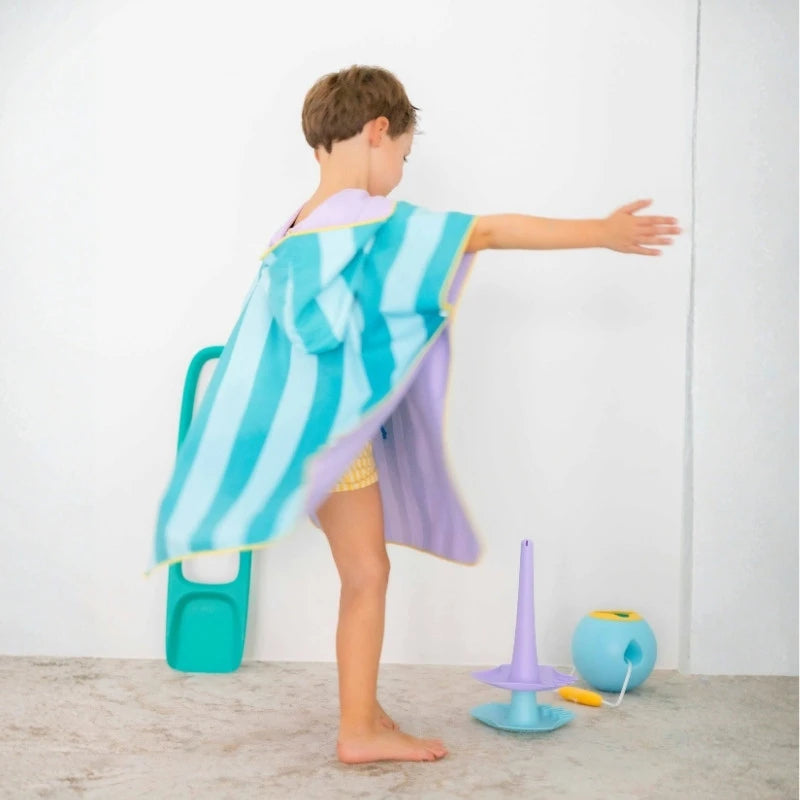Kids putting on ponchos before poolside play