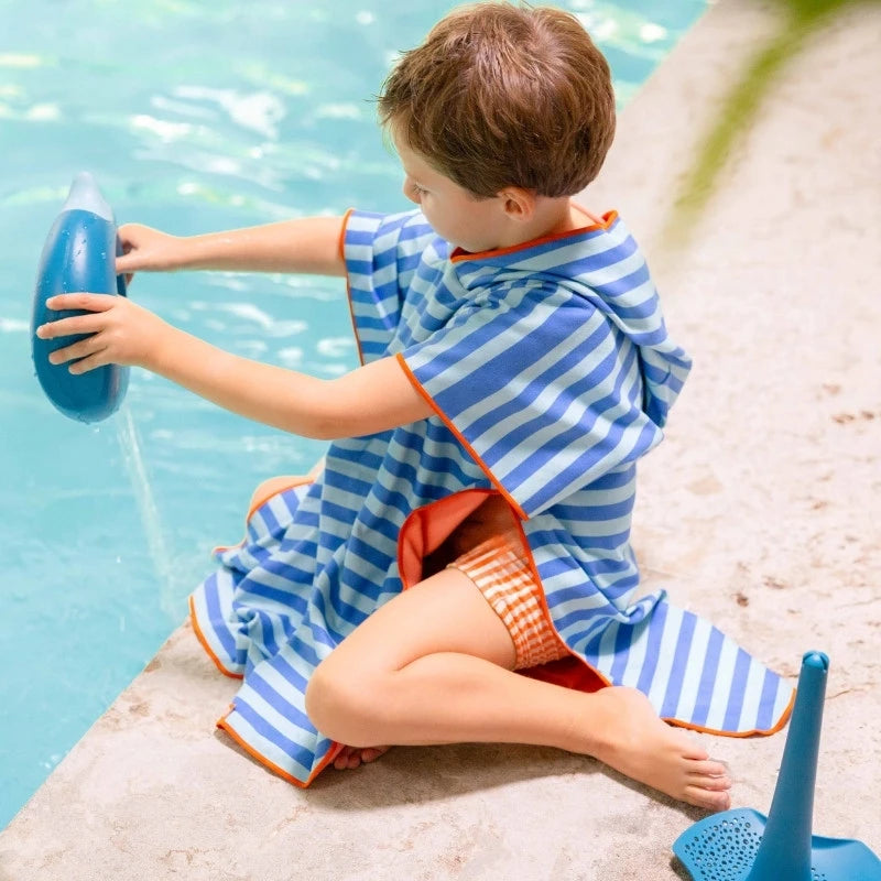 Children laughing and twirling in colorful microfiber ponchos