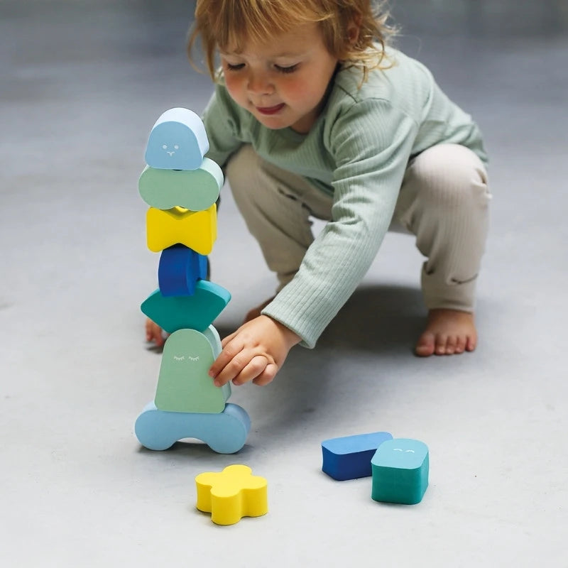 Toddlers playing together with quiet foam blocks on the floor
