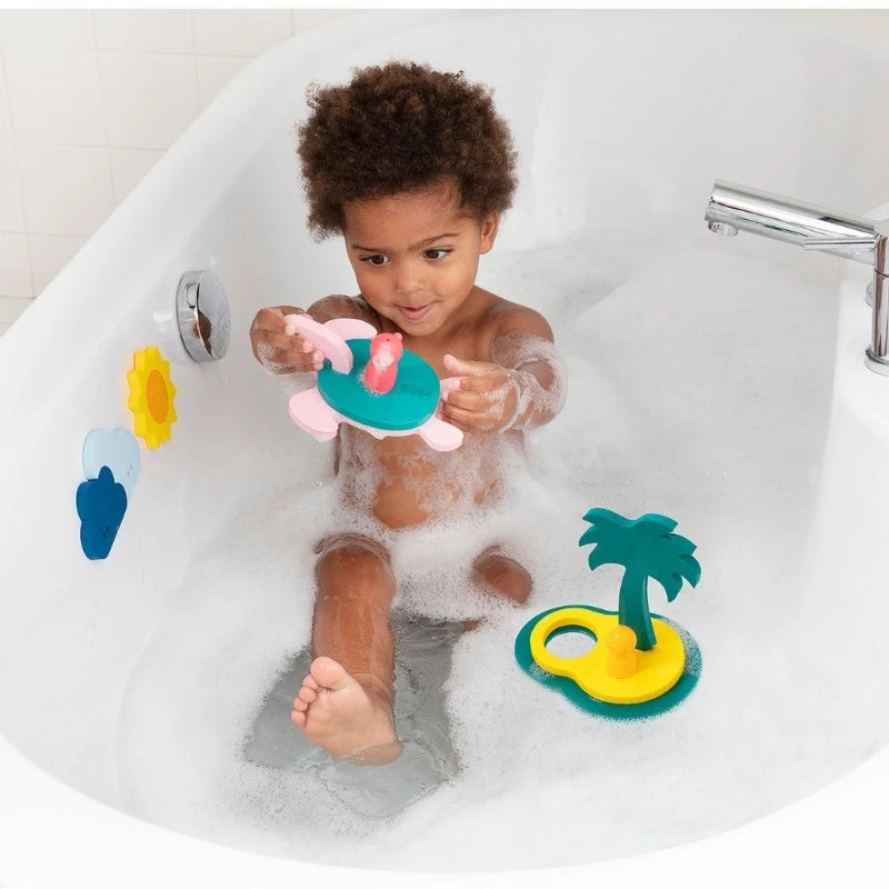 Toddlers smiling and exploring Puzzle Friends Treasure Island during bath time