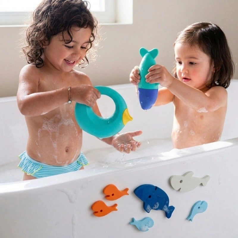 Toddlers squeeze the Squeezi Shark, stick Bath Puzzle Shark pieces, and pour water with the Cana for engaging, safe bath-time play.