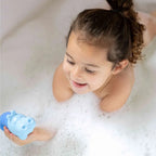 Child pouring water from Squeezi Hippo to explore water flow