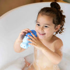 Kids enjoying bath play with multiple Squeezi Hippo toys
