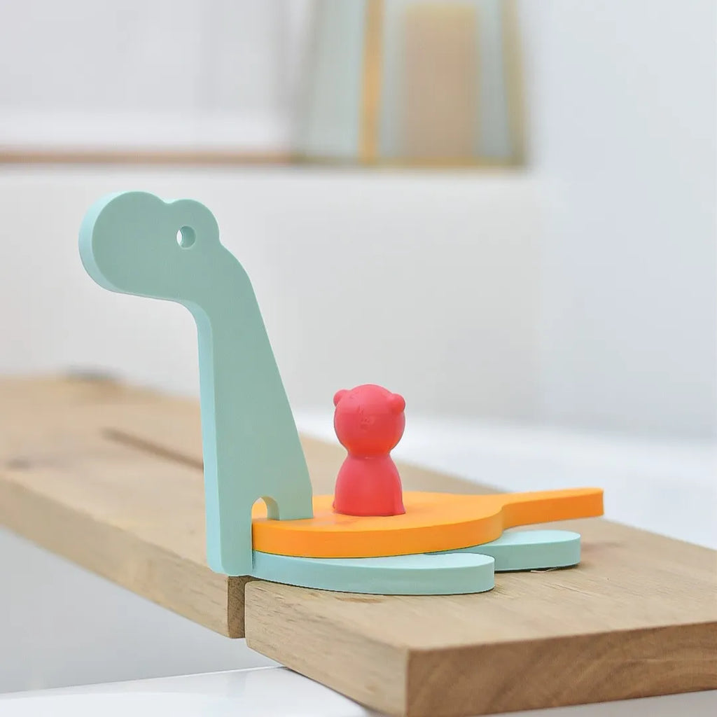 Puzzle Friends Dino World set arranged to create a prehistoric scene in the bath